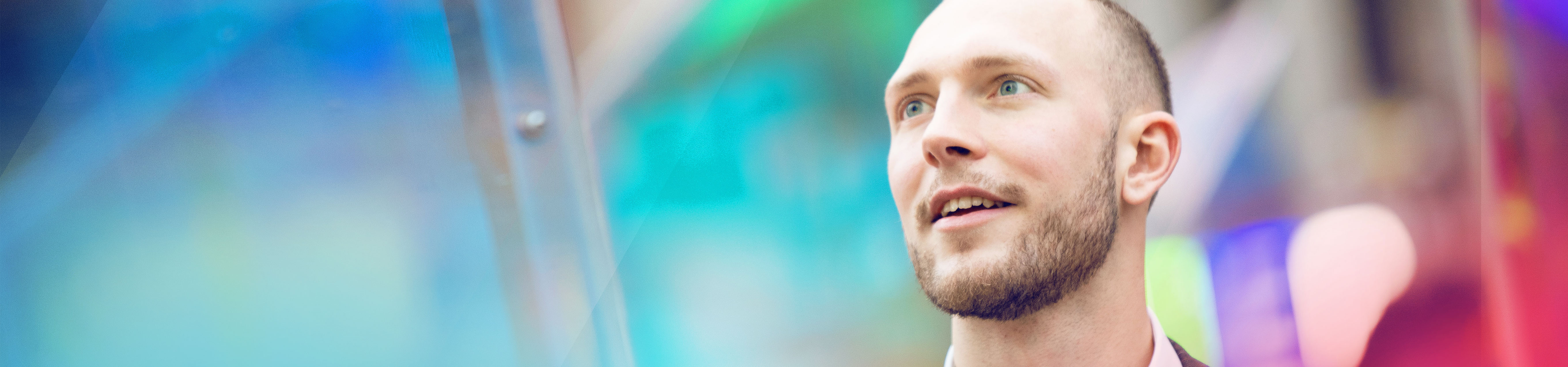 German is standing in front of a colourful background