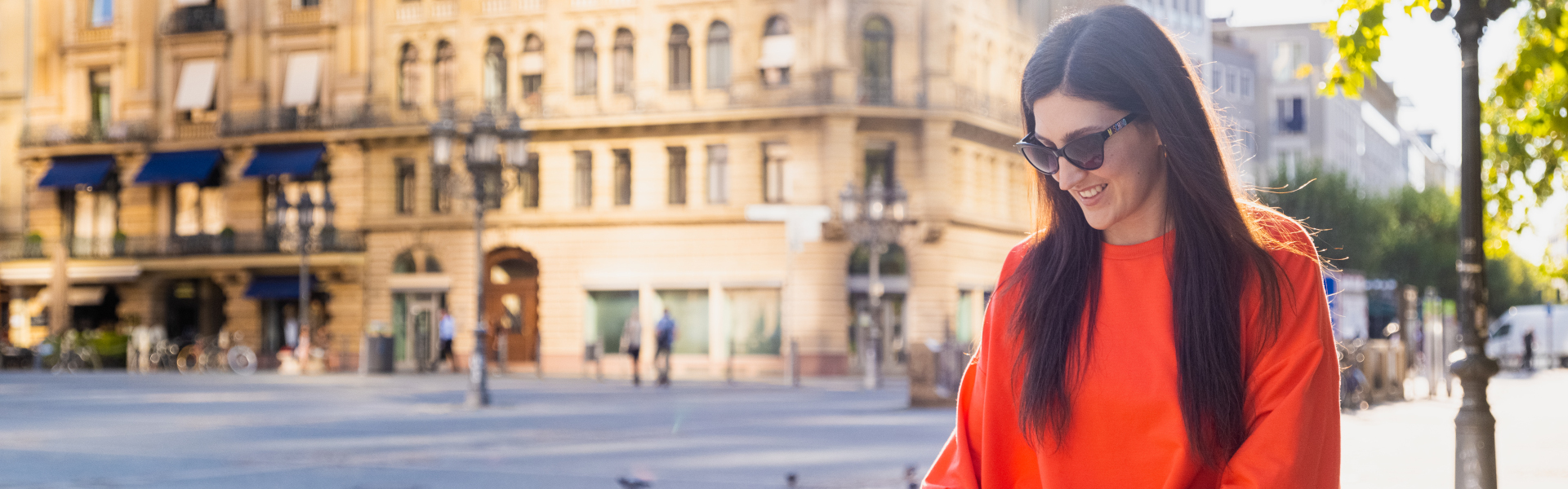 Woman in red on the street in background building